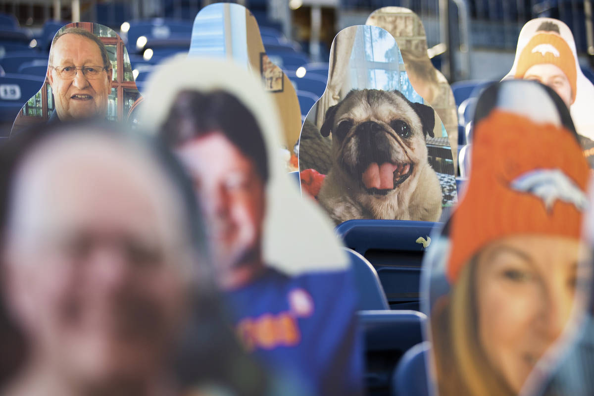 Cardboard cutouts line the stands at Empower Field at Mile High Stadium during an NFL football ...