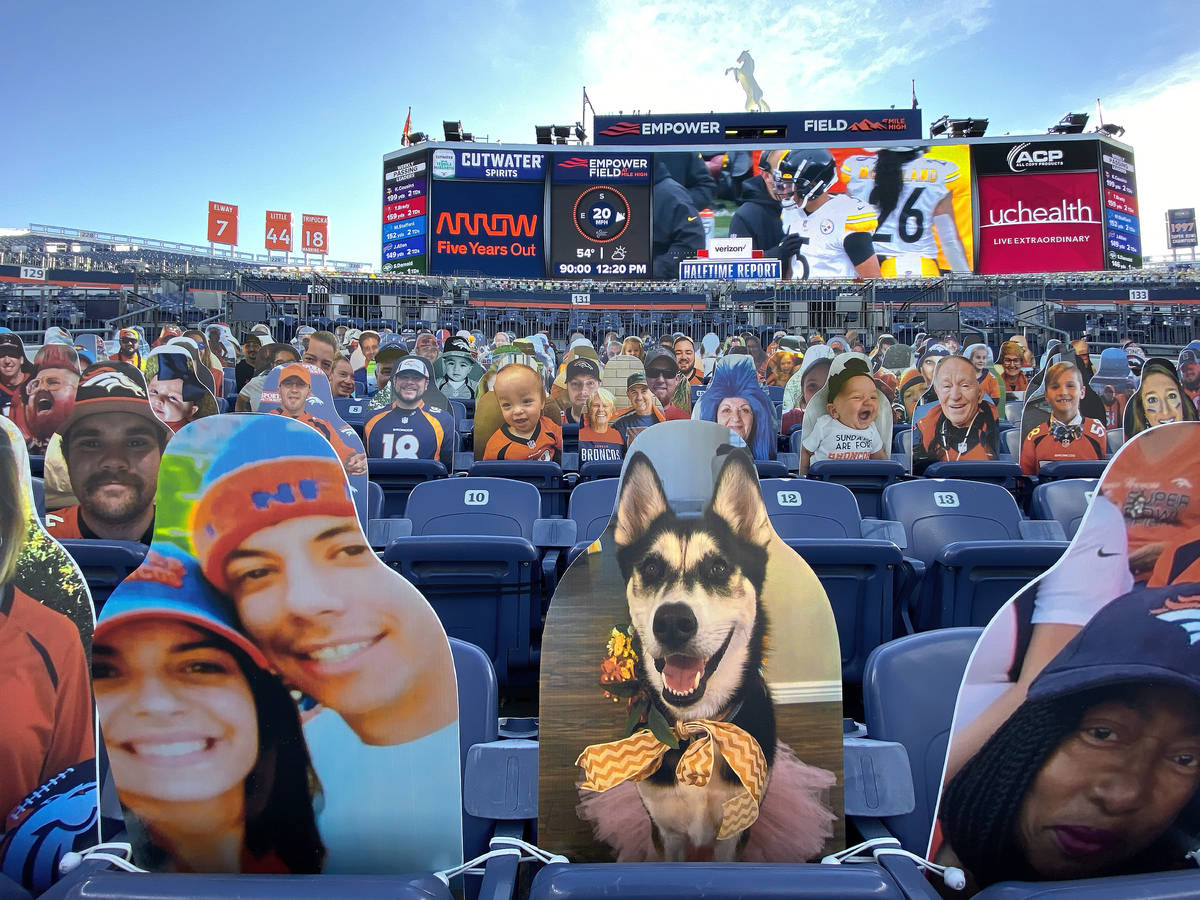 Cardboard cutouts line the stands at Empower Field at Mile High Stadium during an NFL football ...
