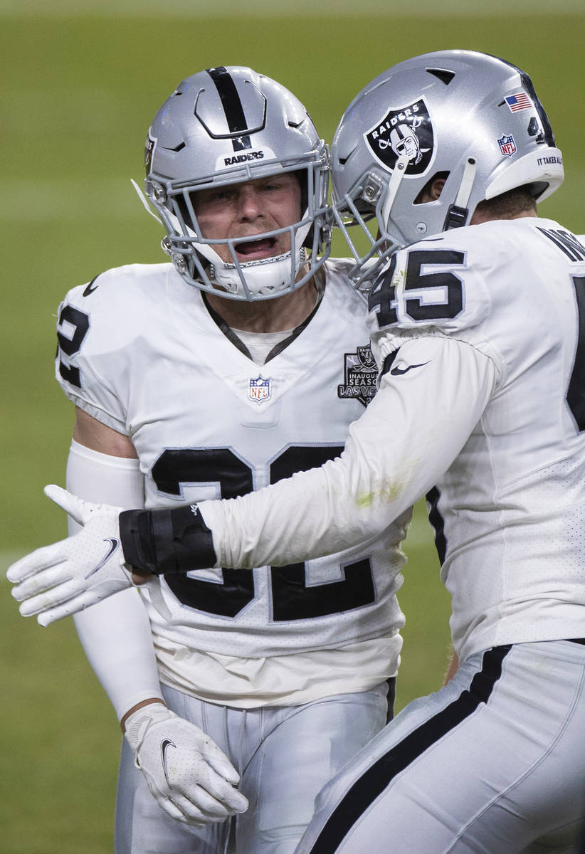 Raiders safety Dallin Leavitt (32) celebrates a big special teams play with Raiders fullback Al ...