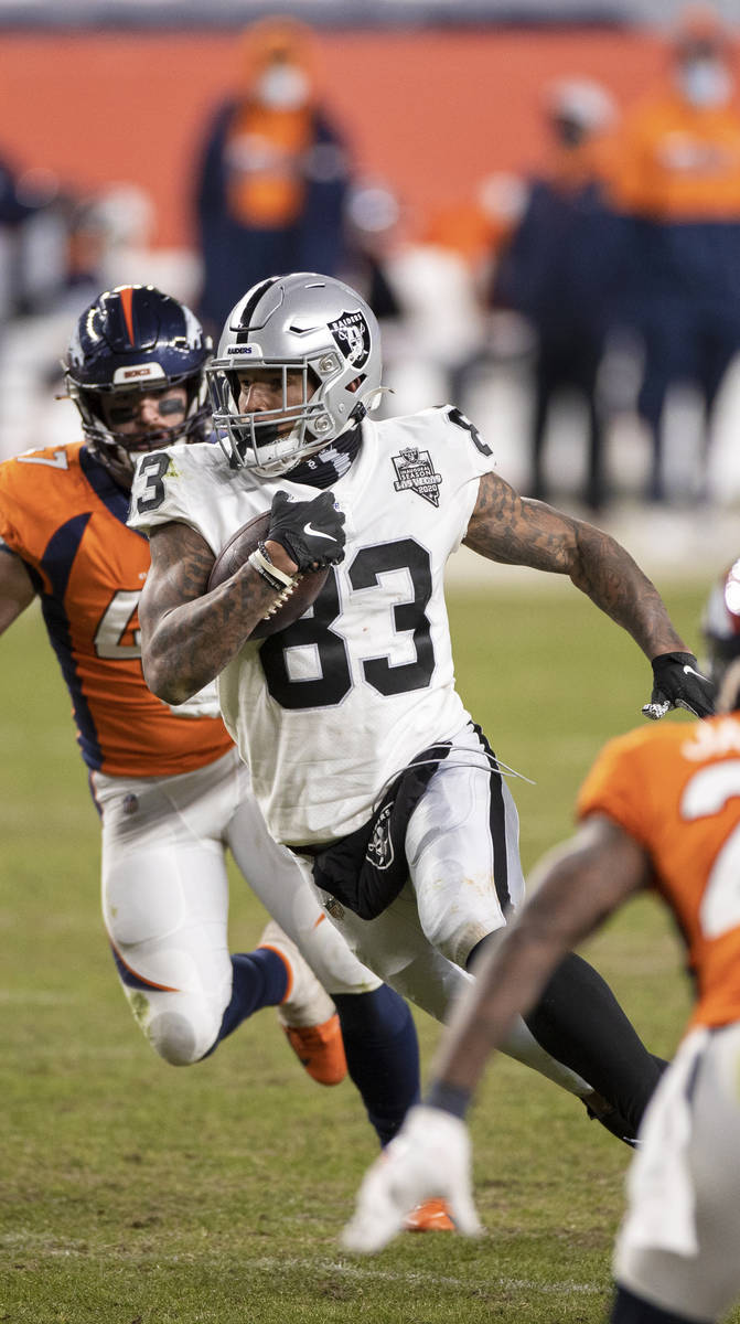 Raiders tight end Darren Waller (83) makes a big run and catch past Denver Broncos inside lineb ...