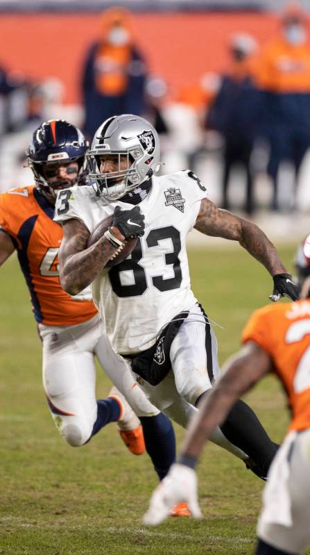 Raiders tight end Darren Waller (83) makes a big run and catch past Denver Broncos inside lineb ...