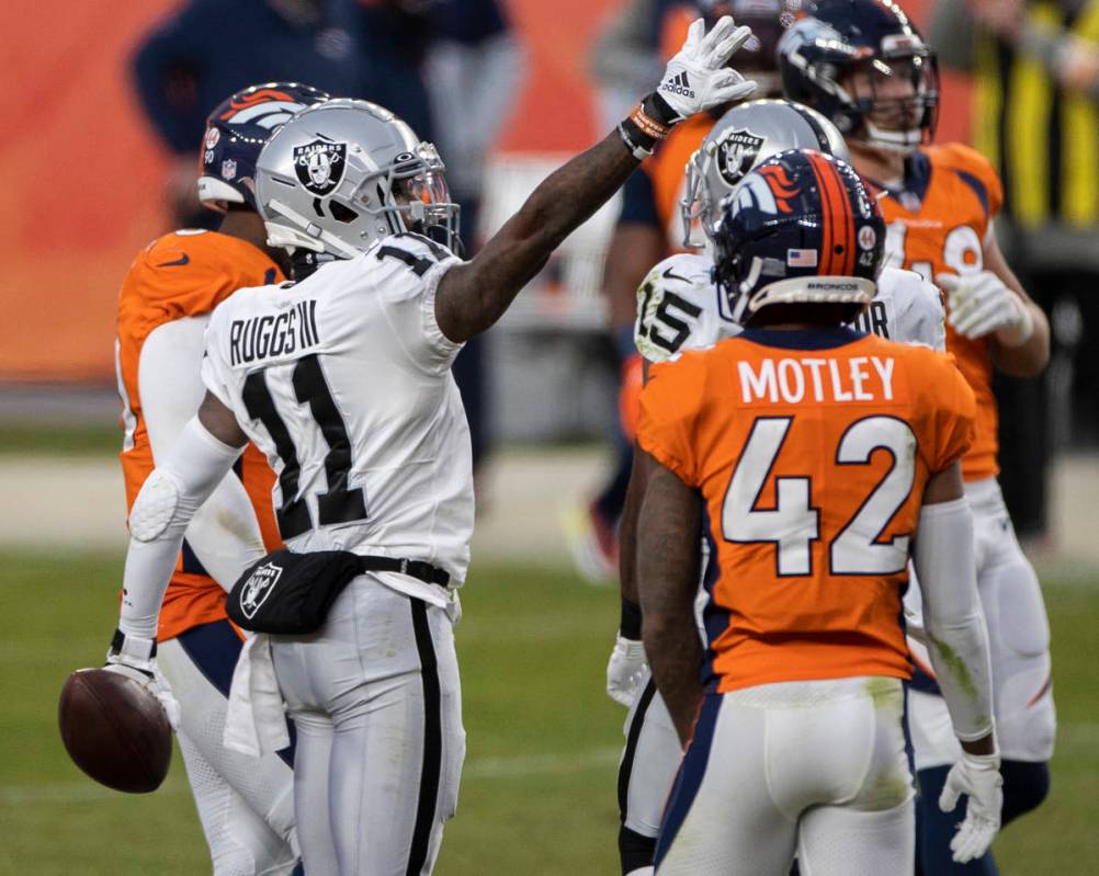 Raiders wide receiver Henry Ruggs III (11) signals a first down in the face of Denver Broncos c ...