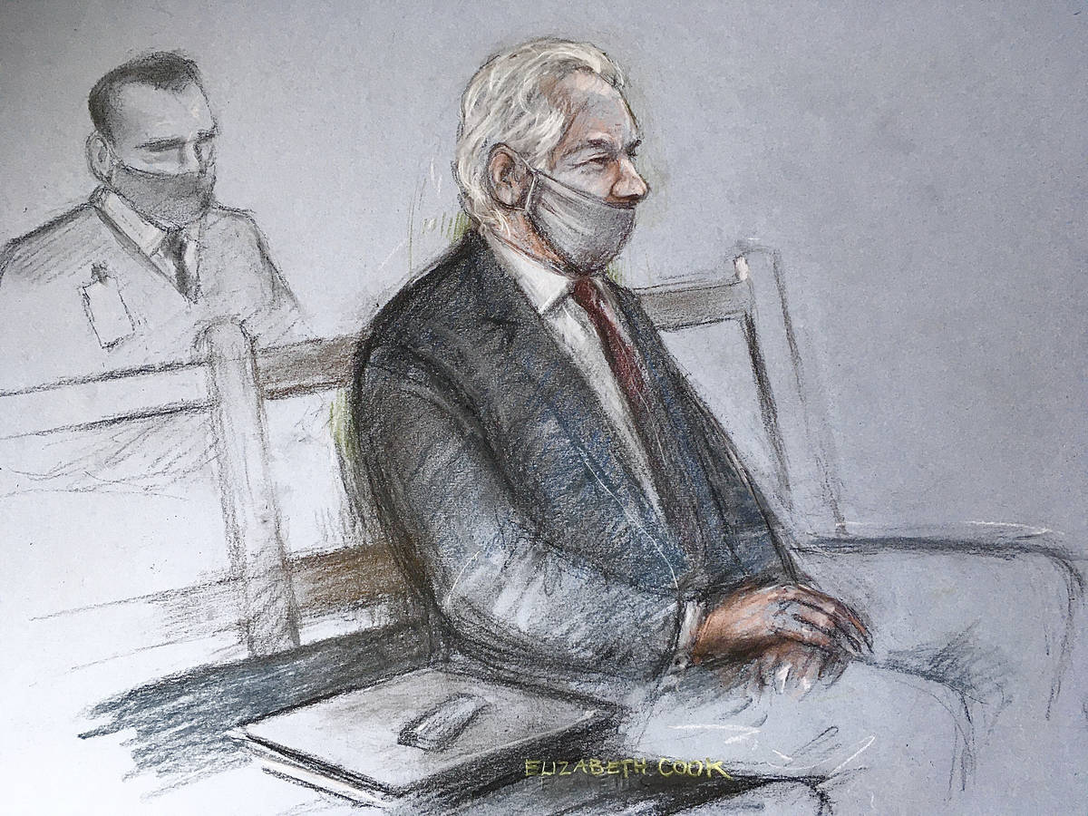 This is a court artist sketch by Elizabeth Cook of Julian Assange appearing at the Old Bailey i ...