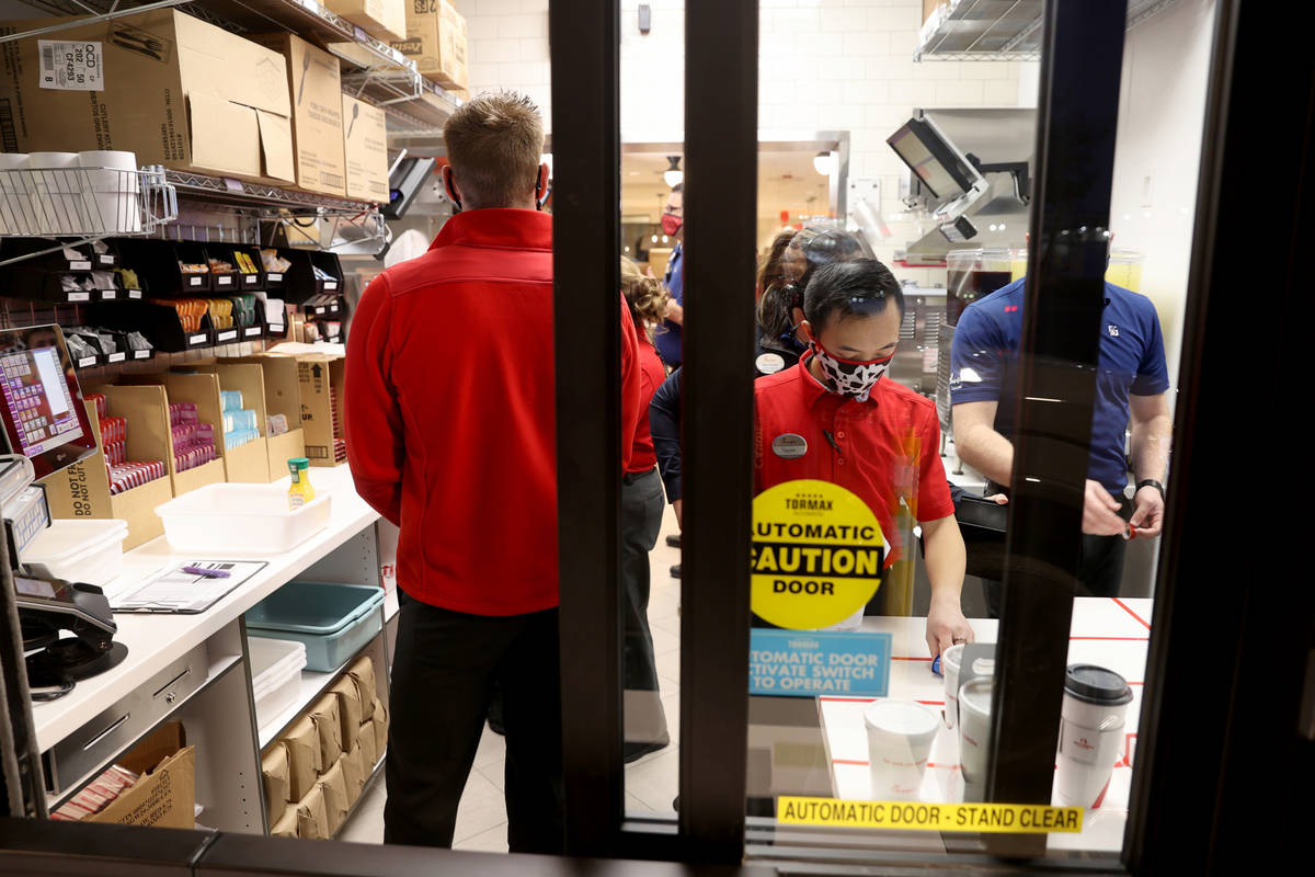 Workers fill orders during the grand opening of the 10th Chick-fil-A restaurant in the Las Vega ...
