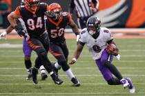 Baltimore Ravens quarterback Lamar Jackson (8) scrambles away from Cincinnati Bengals defensive ...