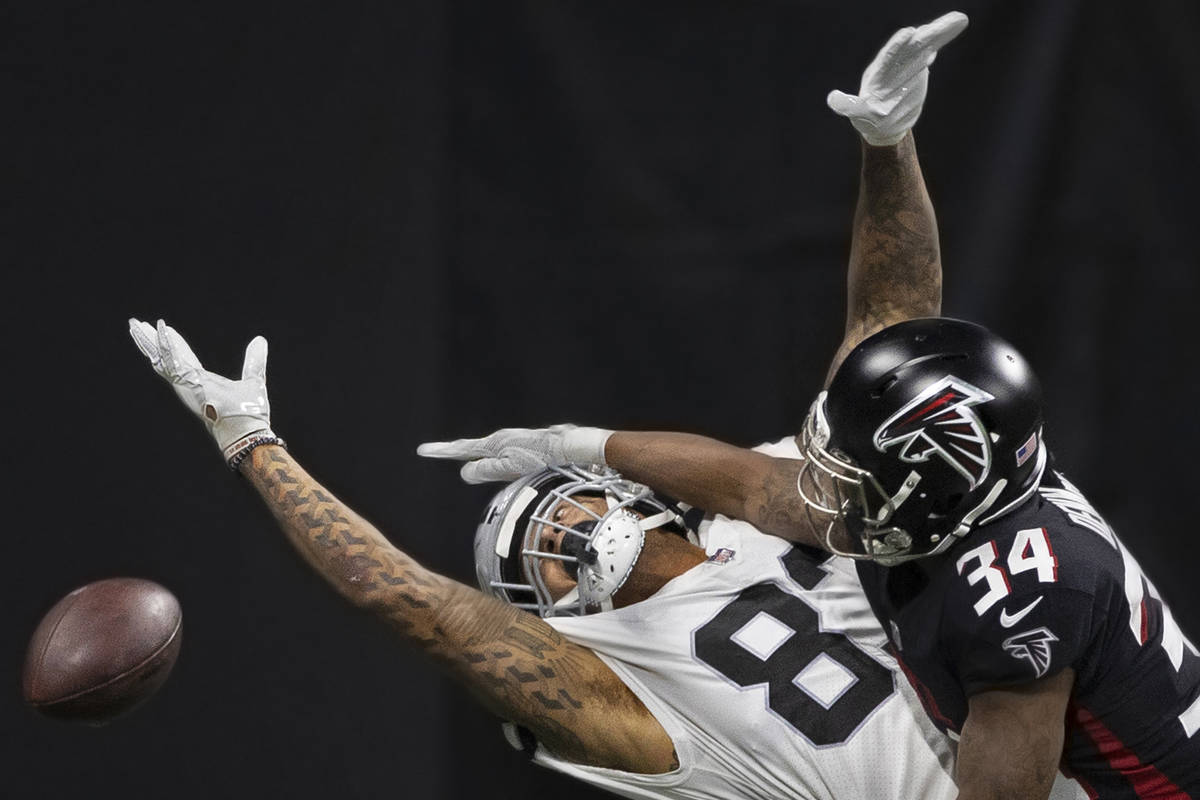 Raiders tight end Darren Waller (83) extends to try and make a catch over Atlanta Falcons corne ...