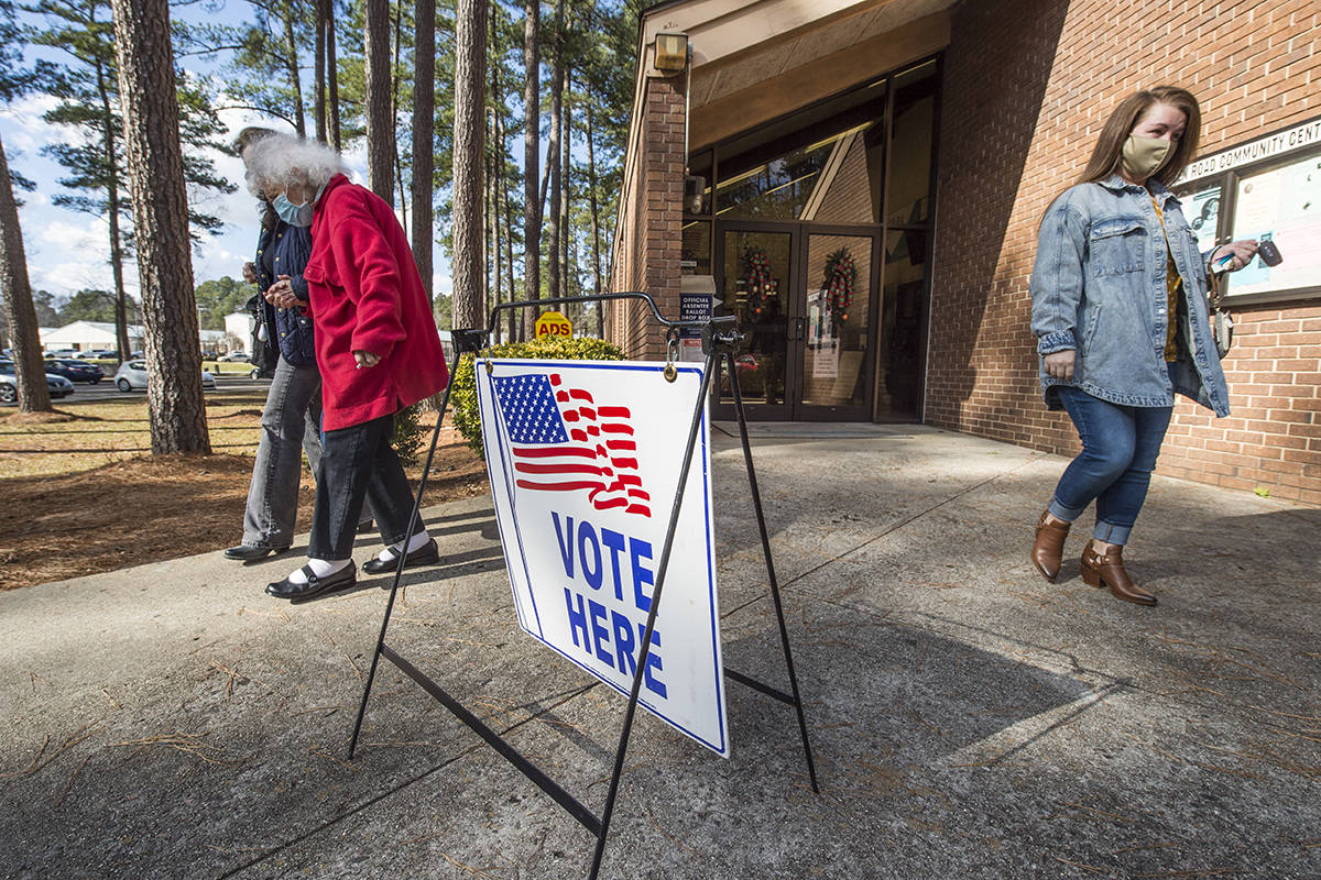 Voters leave the Warren Road Community Center after casting their ballots in Georgia's much ant ...