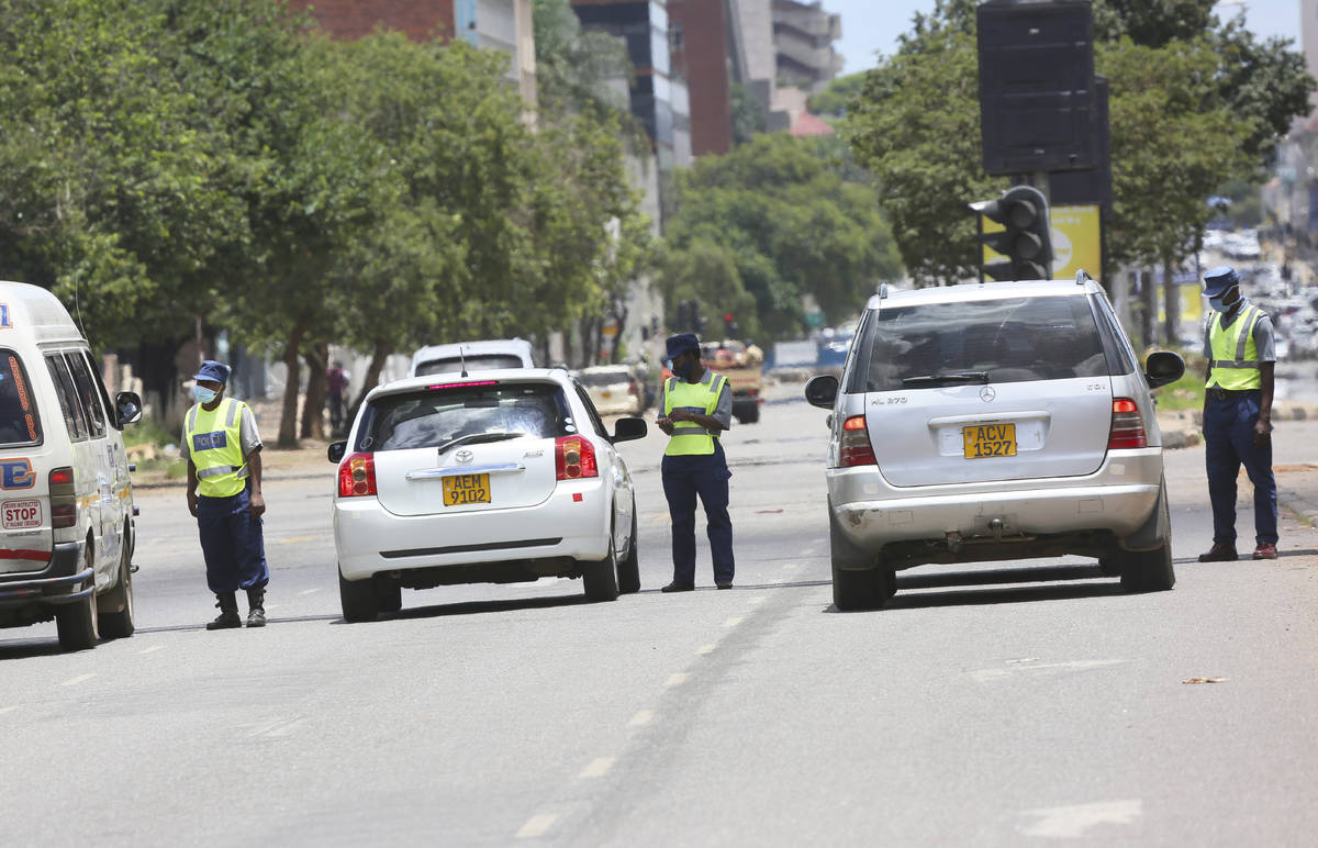 Police stop motorists on the streets of Harare, Tuesday, Jan, 5, 2021, as Zimbabwe has began a ...