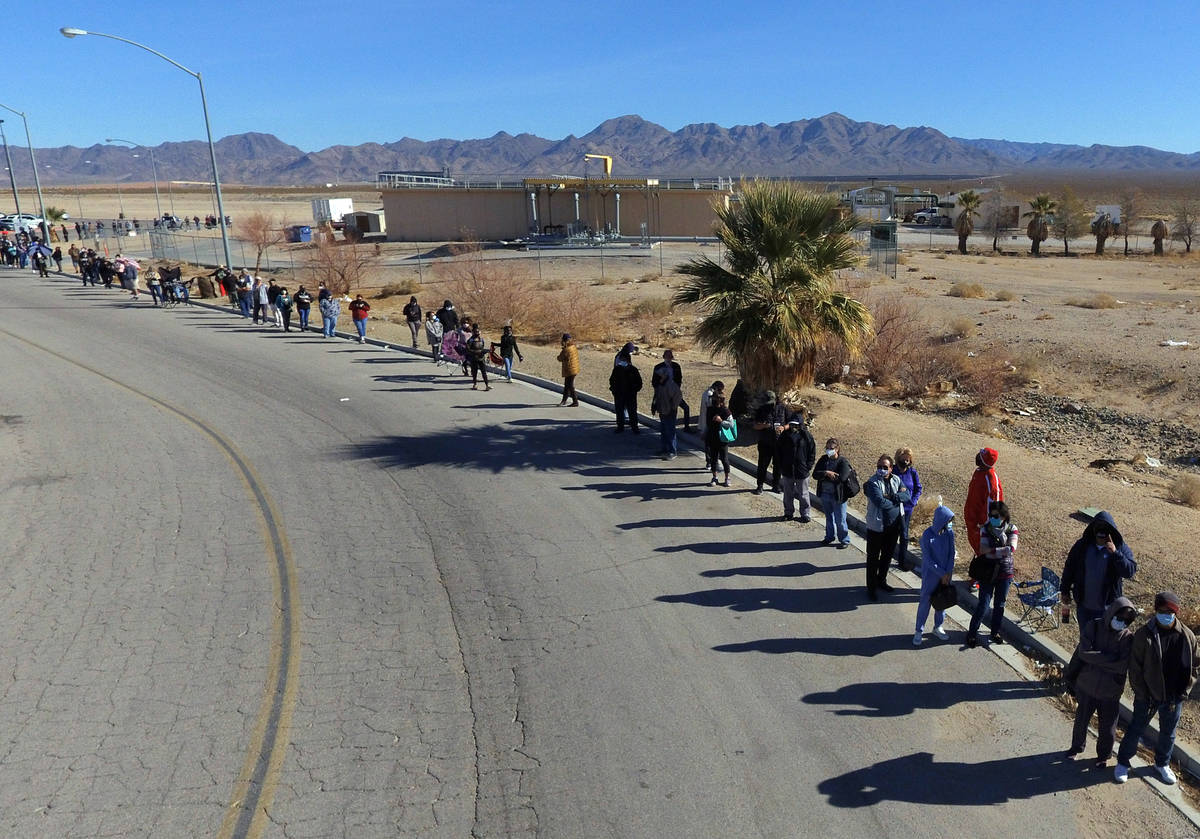 Hundreds line up outside of The Lotto Store at Primm as people wait to buy Mega Millions and Po ...