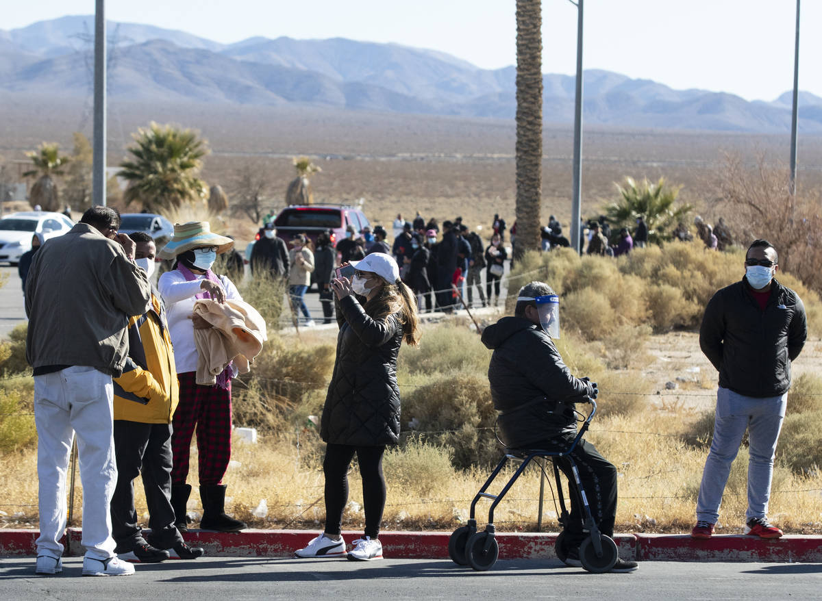 Hundreds line up outside of The Lotto Store at Primm as people wait to buy Mega Millions and Po ...