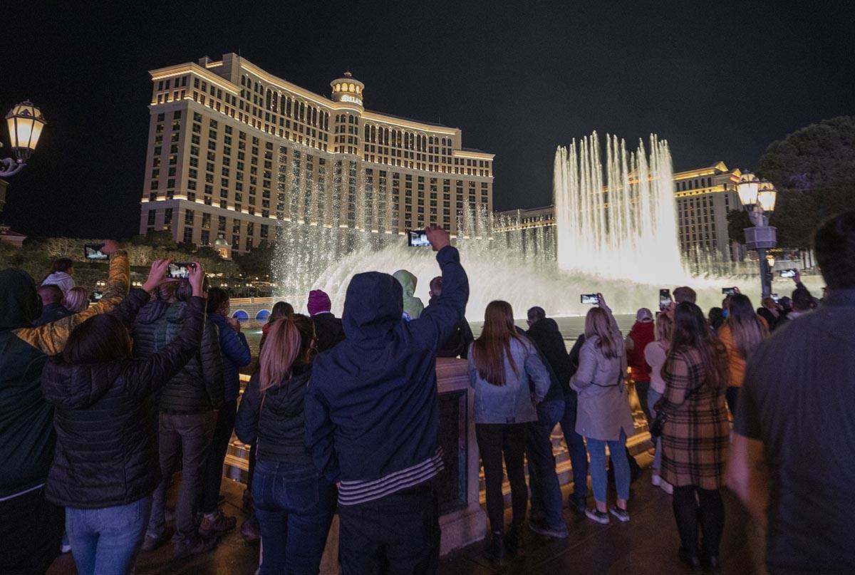 A crowd watches the Fountains at Bellagio on the Strip, Friday, Nov. 27, 2020, in Las Vegas. (E ...