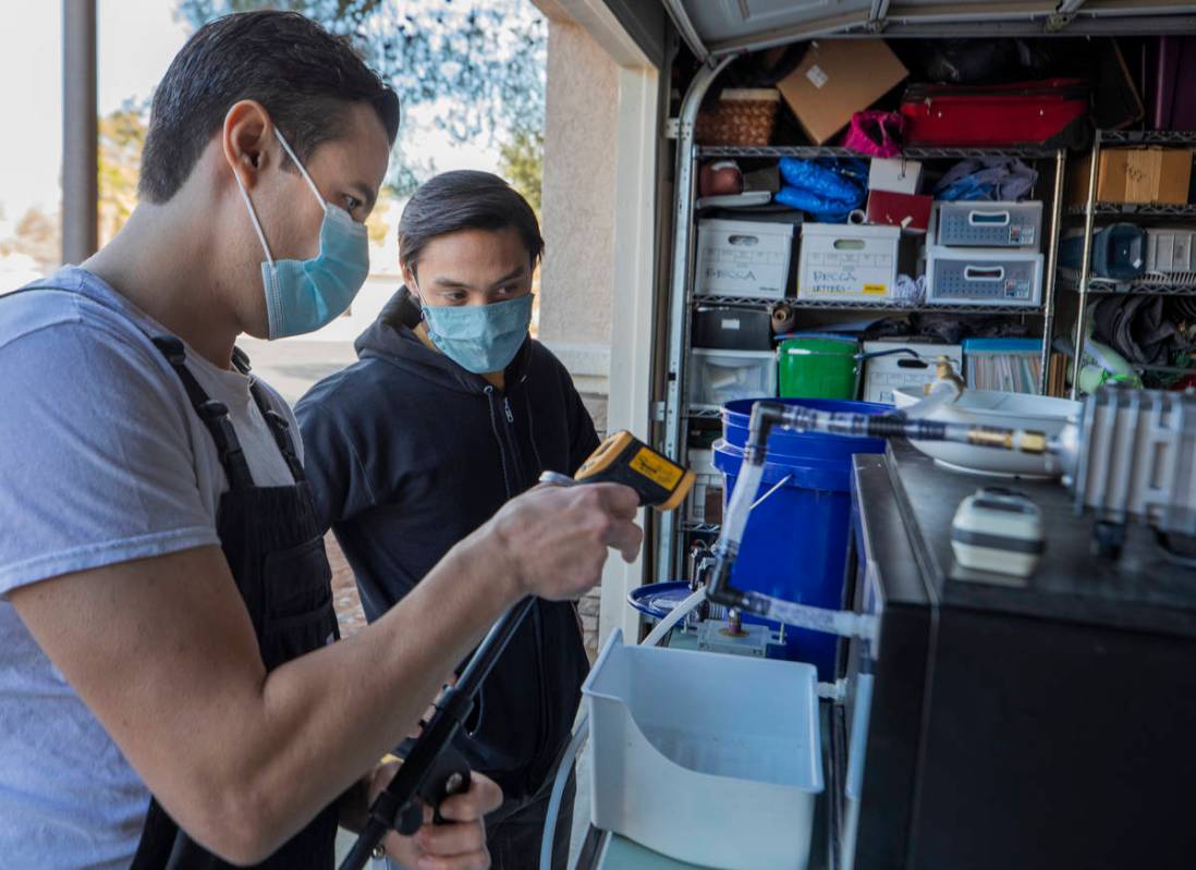 UNLV graduates Scott Isler, 33, left, and Jeffrey Topacio, 32, work on their project, "Mic ...