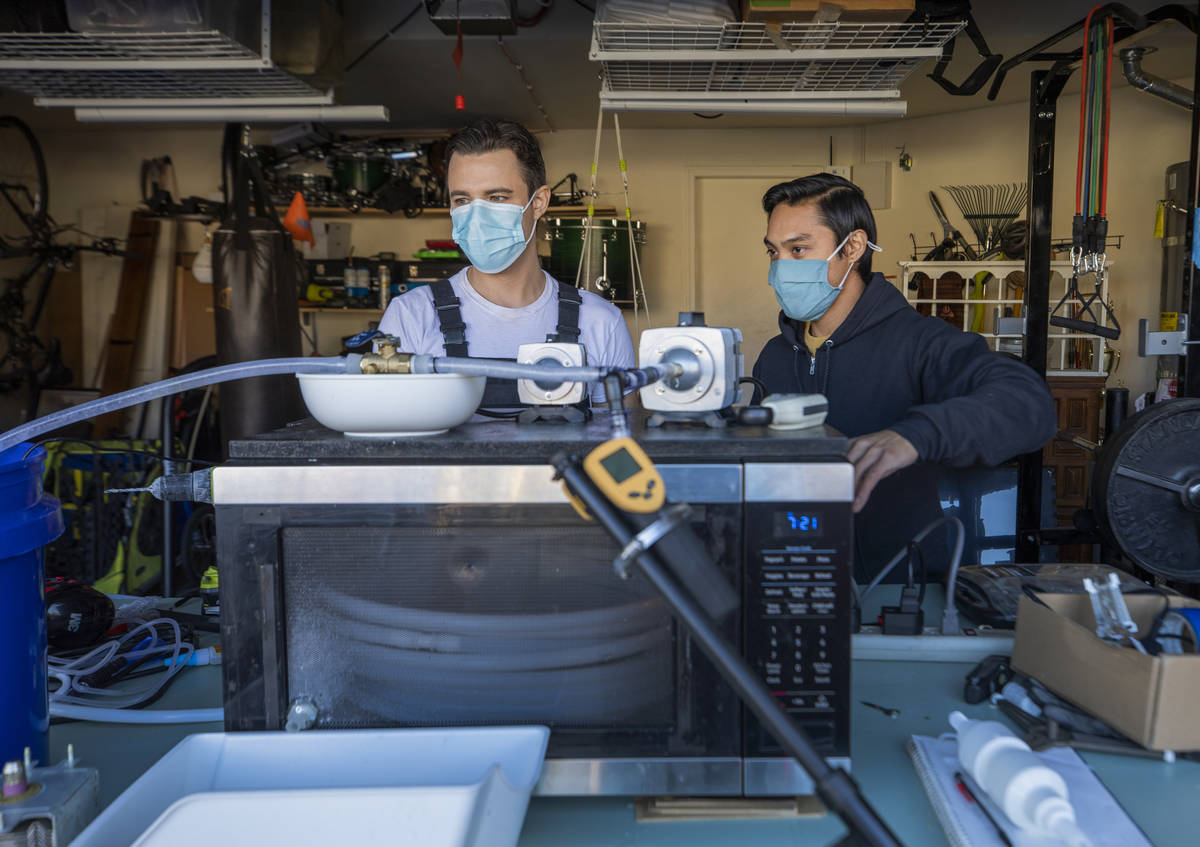 UNLV graduates Scott Isler, 33, left, and Jeffrey Topacio, 32, work on their project, "Mic ...