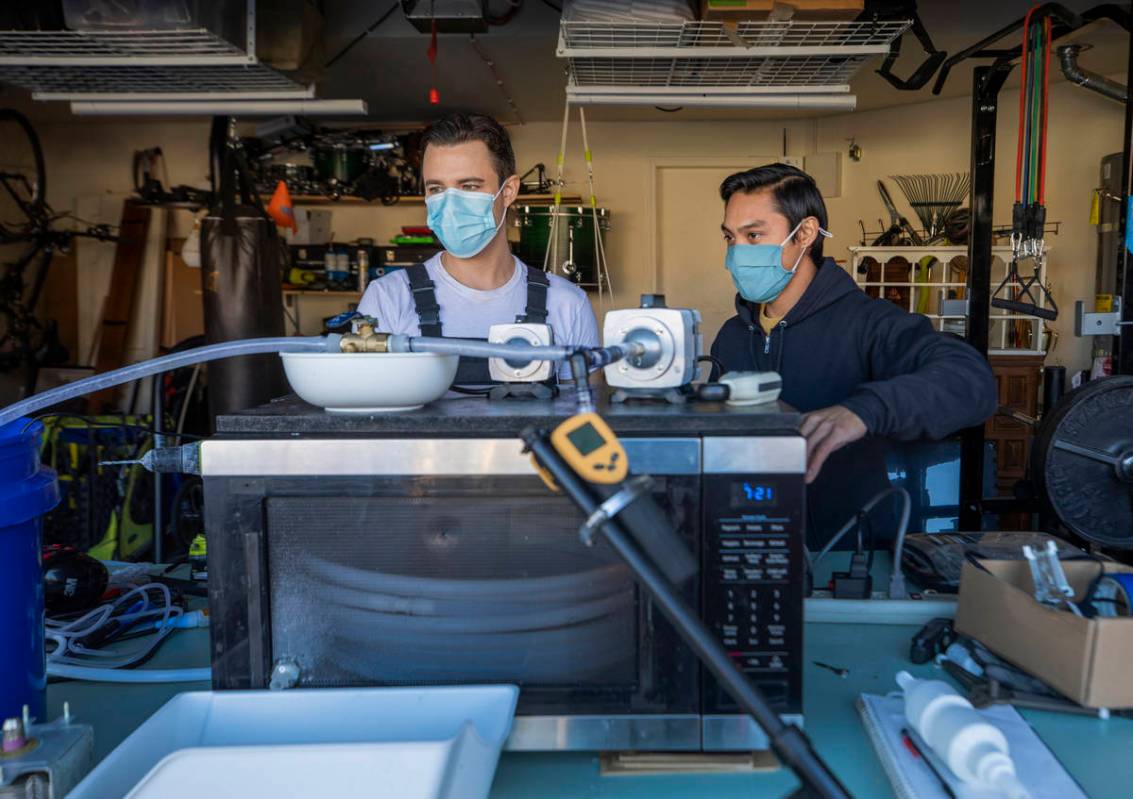 UNLV graduates Scott Isler, 33, left, and Jeffrey Topacio, 32, work on their project, "Mic ...