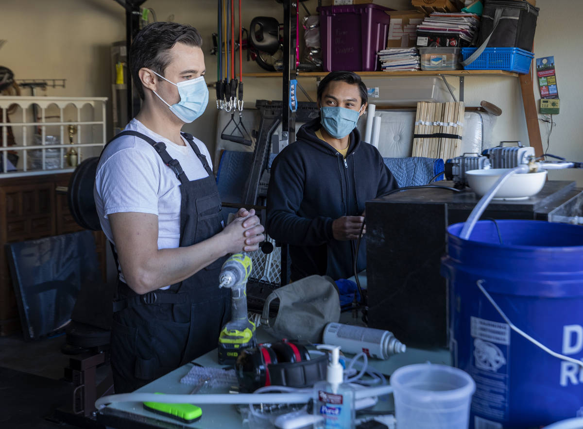 UNLV graduates Scott Isler, 33, left, and Jeffrey Topacio, 32, work on their project, "Mic ...