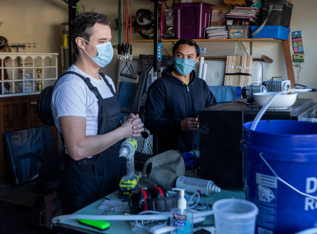 UNLV graduates Scott Isler, 33, left, and Jeffrey Topacio, 32, work on their project, "Mic ...