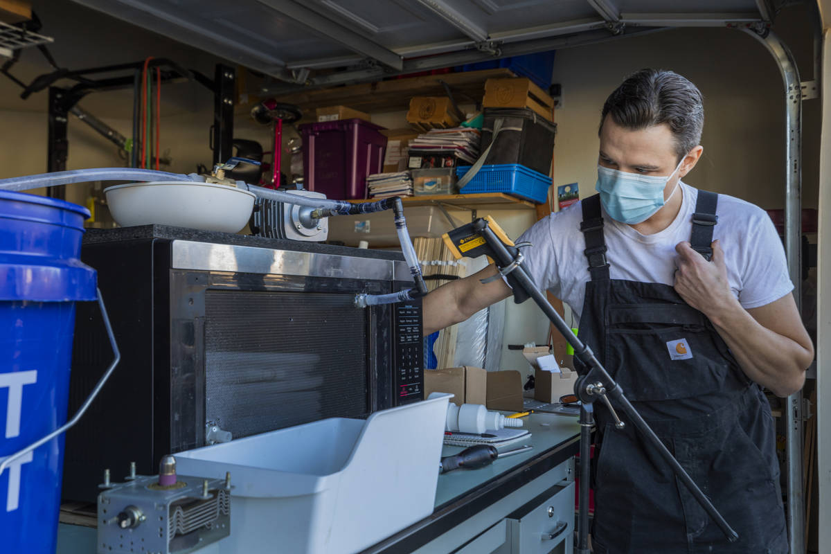 UNLV graduates Jeffrey Topacio, 32, left, and Scott Isler, 33, work on their project, "Mic ...