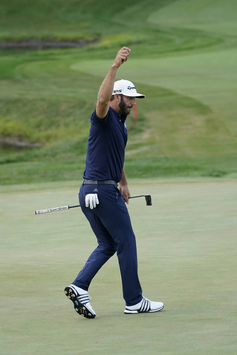 Dustin Johnson reacts after making a birdie putt on the 18th hole during the final round of the ...