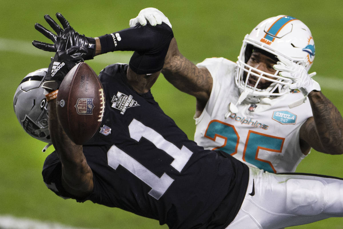 Raiders wide receiver Henry Ruggs III (11) is unable to catch the ball as Miami Dolphins corner ...