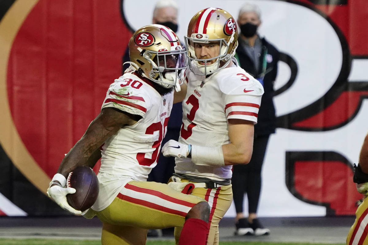 San Francisco 49ers running back Jeff Wilson (30) celebrates his touchdown with quarterback C.J ...