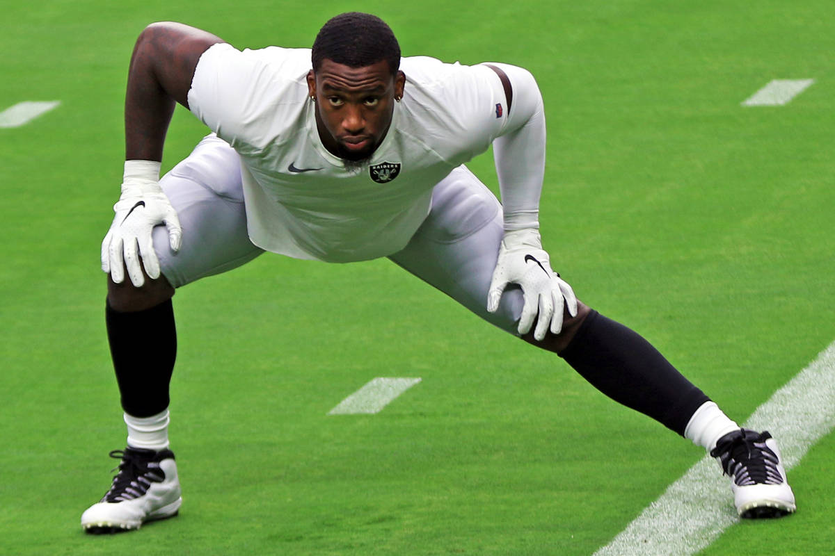 Las Vegas Raiders defensive end Clelin Ferrell stretches on the field prior to a team practice ...