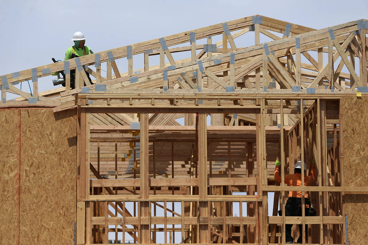 Workers on the roof of a new home construction in Skye Canyon community in Las Vegas, Thursday, ...