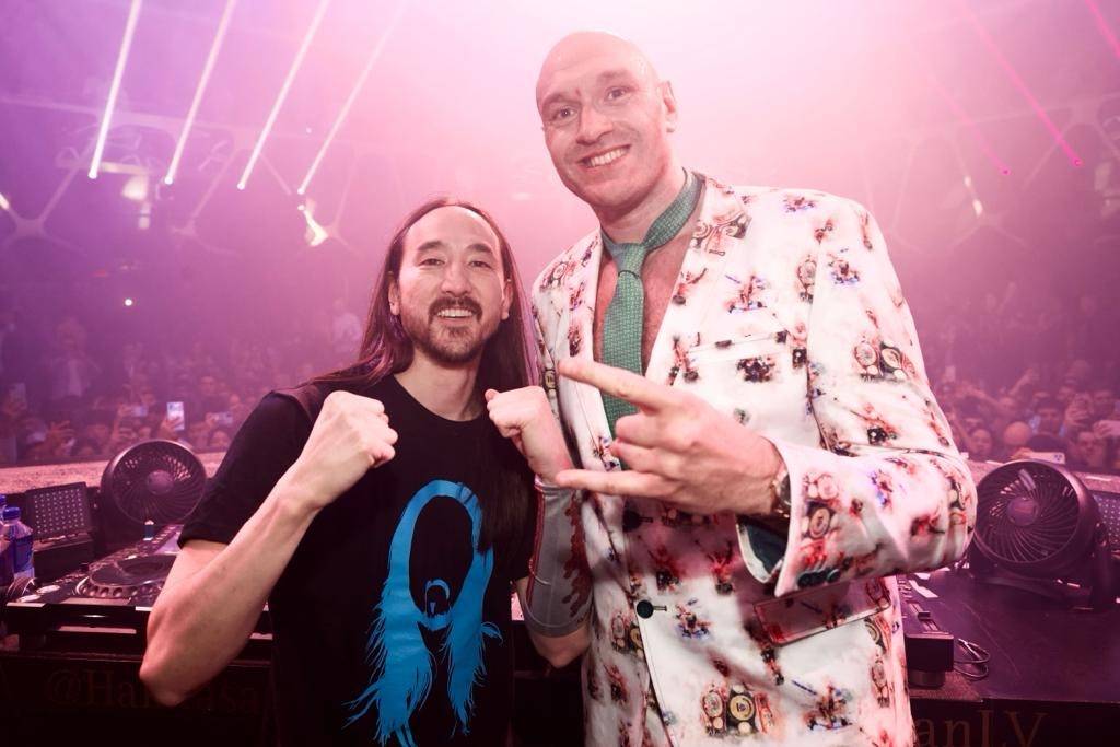 Tyson Fury, right, and DJ superstar Steve Aoki are shown celebrating his seventh-round TKO vict ...