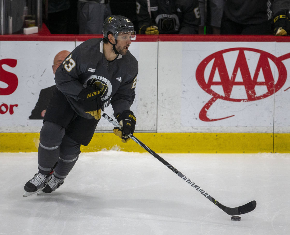 Golden Knights defenseman Alec Martinez (23) dribbles the puck on the ice during training camp ...