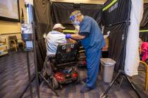 Veteran Levi Williams, left, is patched up after receiving a shot from RN Darrel Cowlishaw as s ...