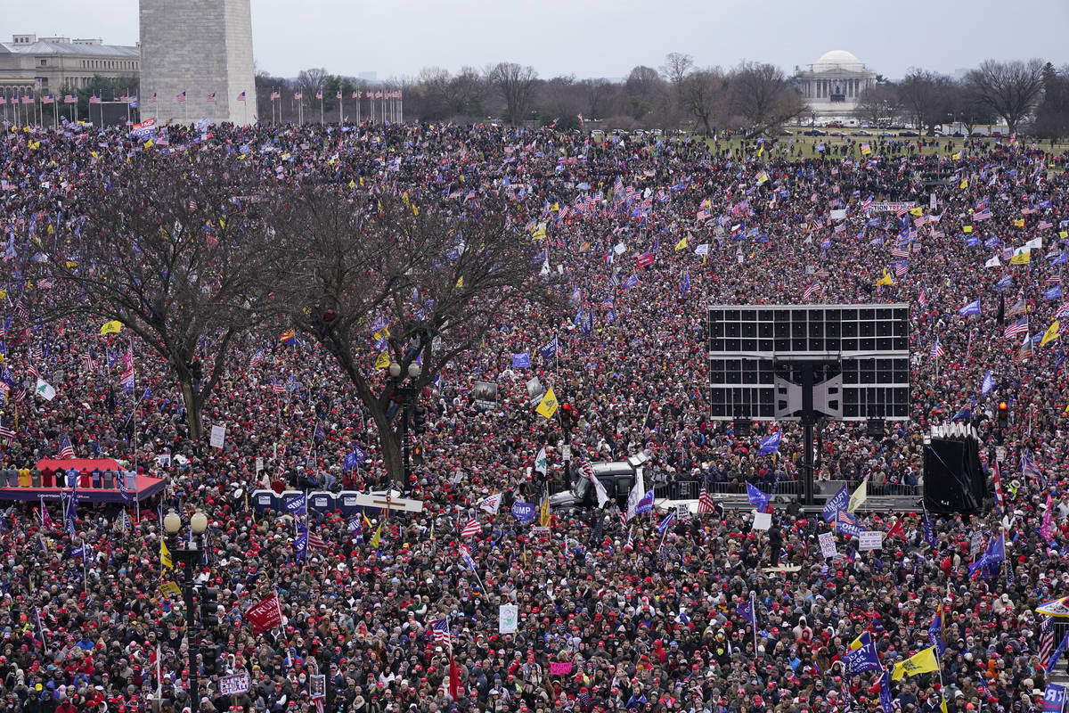 With the Washington Monument in the background, people attend a rally in support of President D ...