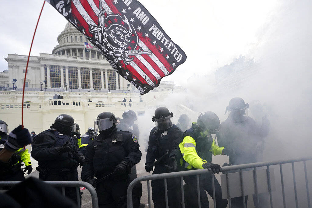 Police hold off Trump supporters who tried to break through a police barrier, Wednesday, Jan. 6 ...