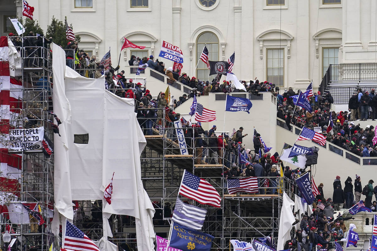 Trump supporters gather outside the Capitol, Wednesday, Jan. 6, 2021, in Washington. As Congres ...