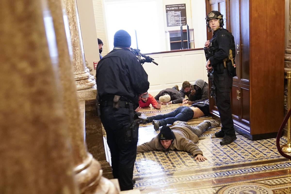 U.S. Capitol Police hold protesters at gun-point near the House Chamber inside the U.S. Capitol ...
