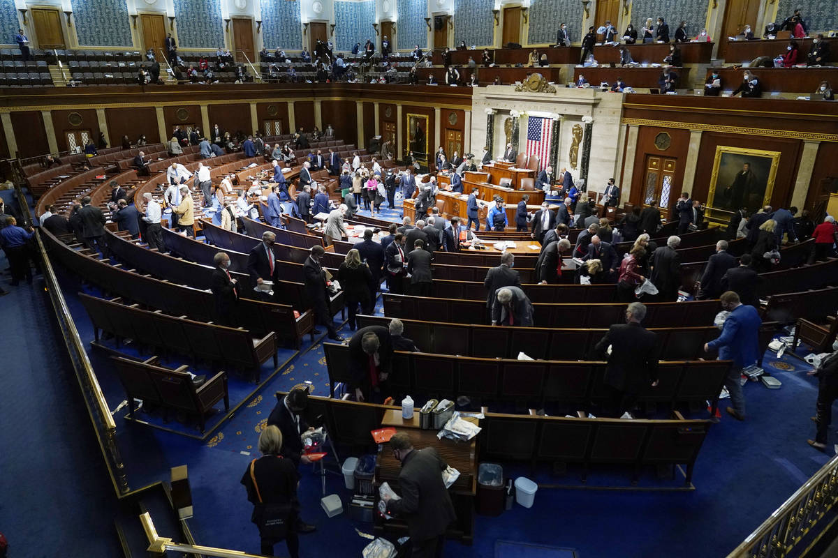 House members prepare to leave the floor as protesters try to break into the House Chamber at t ...