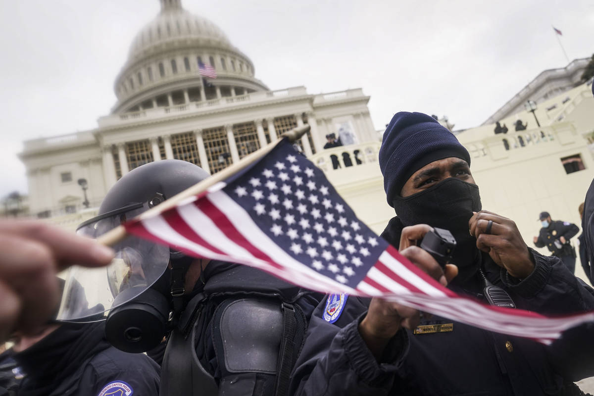 Trump supporters try to break through a police barrier, Wednesday, Jan. 6, 2021, at the Capitol ...