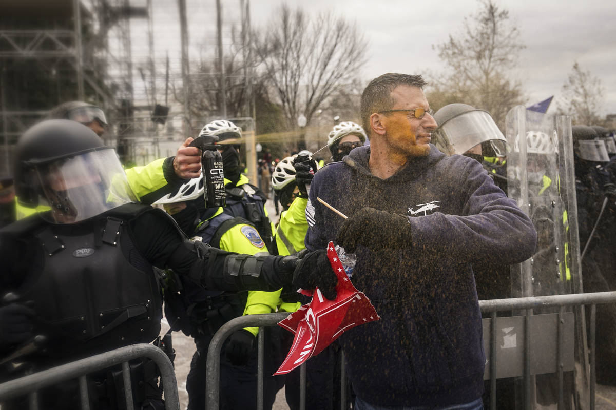 Trump supporters try to break through a police barrier, Wednesday, Jan. 6, 2021, at the Capitol ...