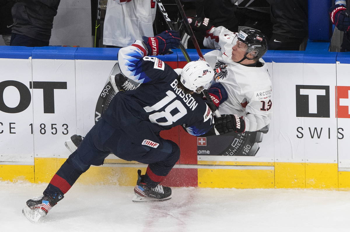 United States' Brendan Brisson (18) checks Austria's Leon Wallner (13) during the second period ...