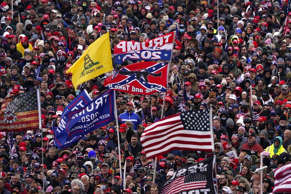 People listen as President Donald Trump speaks during a rally Wednesday, Jan. 6, 2021, in Washi ...