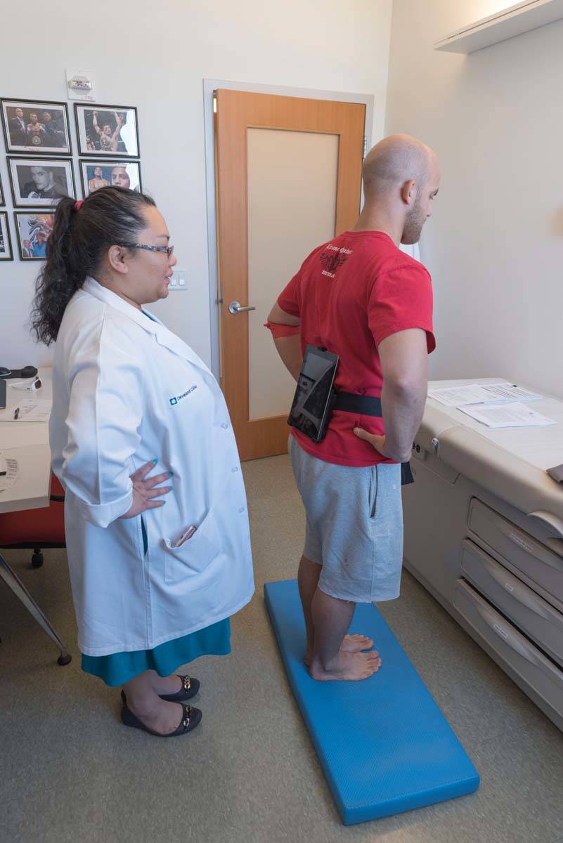 Pamela Dino of Cleveland Clinic administers balance testing as part of the PABHS before the COV ...