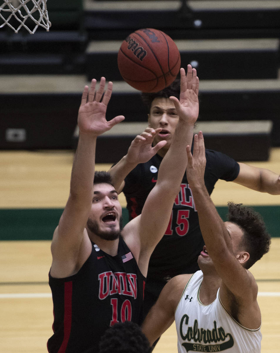 UNLV forward Edoardo Del Cadia, left, blocks a shot from Colorado State guard Isaiah Rivera dur ...