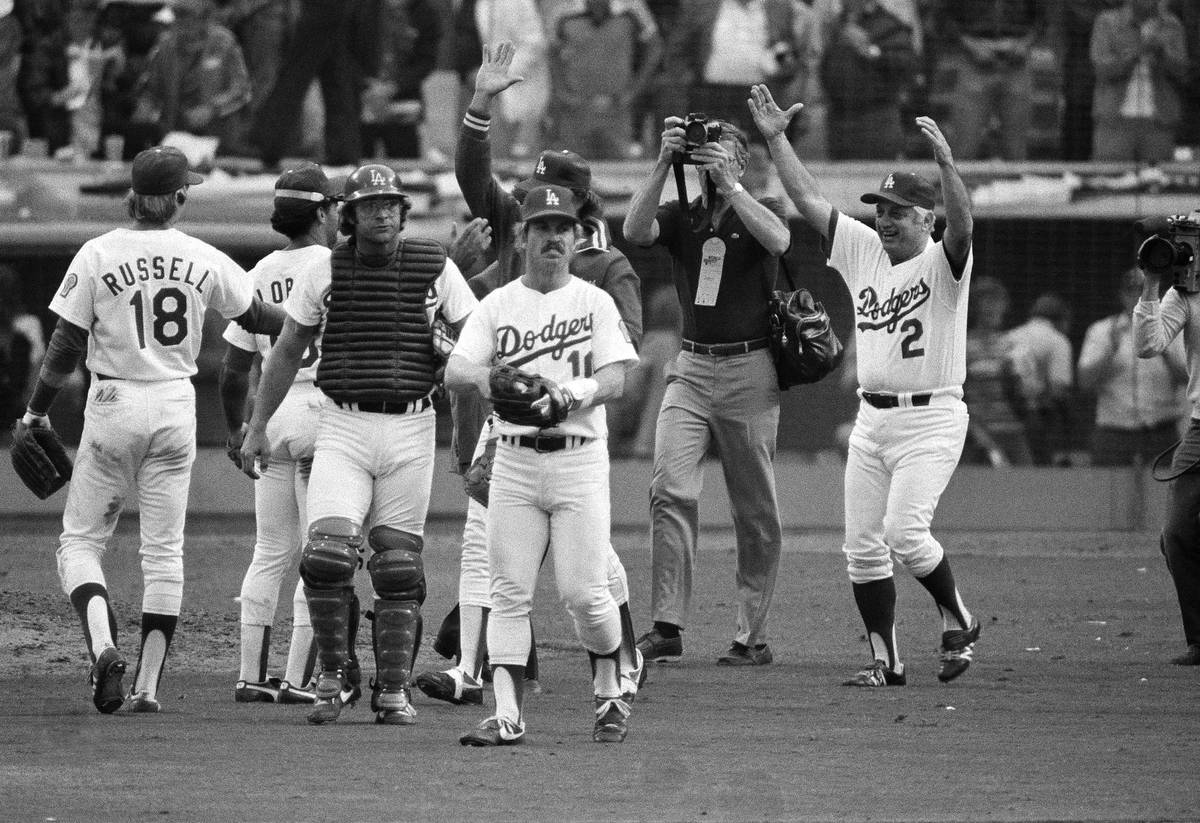 Los Angeles Dodgers manager Tommy Lasorda (2), right, celebrates with his team after their win ...