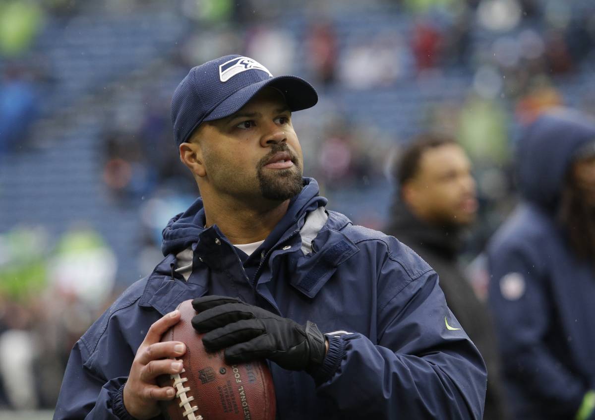 Seattle Seahawks defensive coordinator Kris Richard passes a football during warmups before an ...