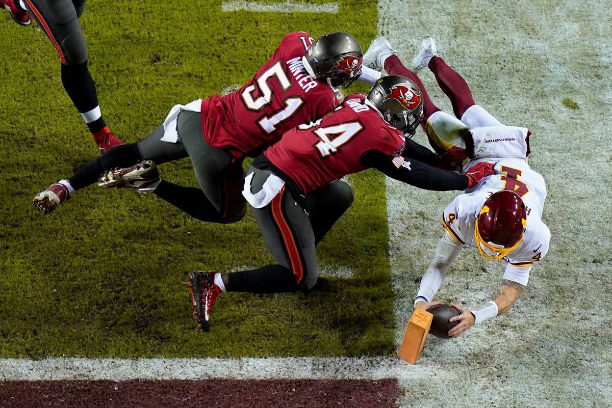 Washington Football Team quarterback Taylor Heinicke (4) dives towards the end zone to score a ...