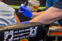 Veteran Levi Williams, left, receives a shot from RN Darrel Cowlishaw as some of the first vete ...