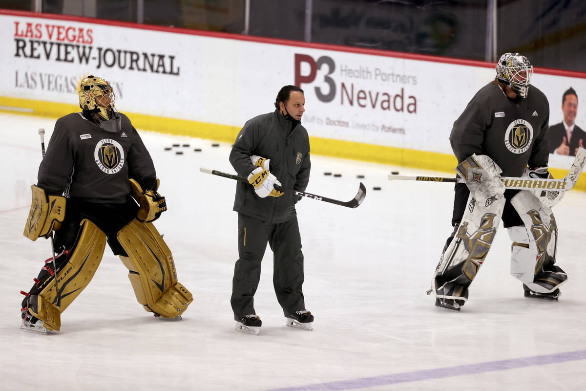 Golden Knights goaltenders Marc-Andre Fleury (29), left, Robin Lehner (90) with coach Mike Rosa ...