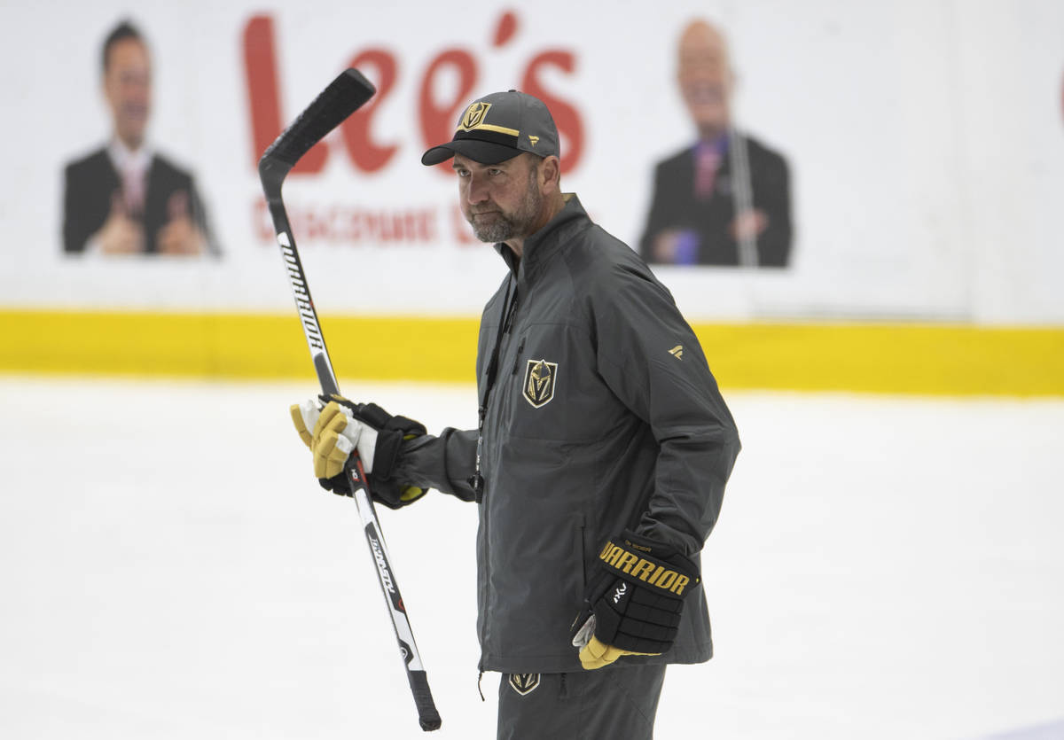 Golden Knights head coach Peter DeBoer watches his players run through drills during practice a ...