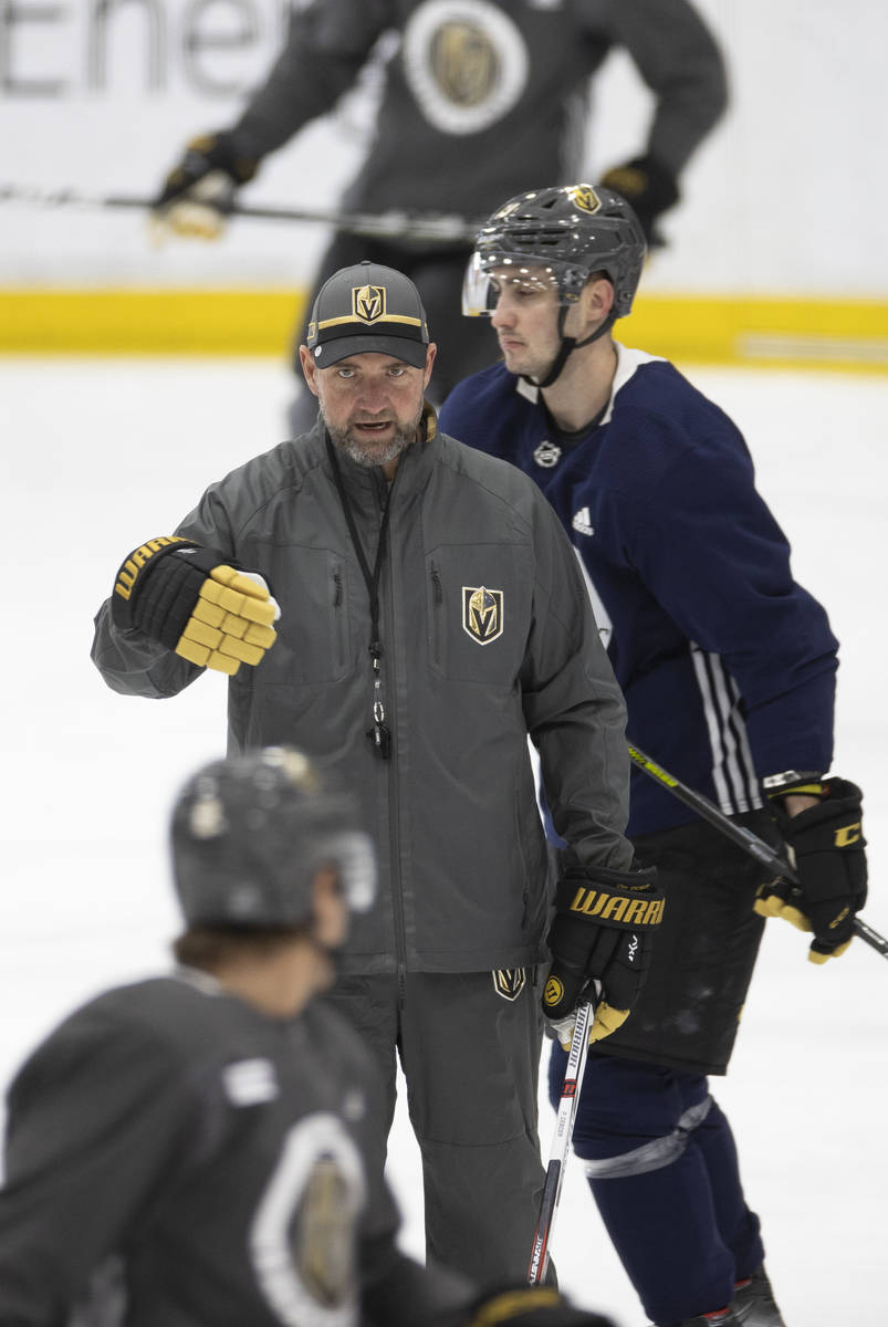 Golden Knights head coach Peter DeBoer gives direction to his players during practice at City N ...