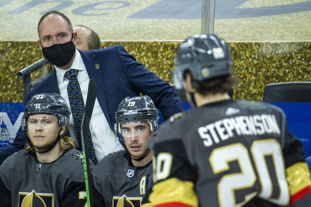 Golden Knights head coach Peter DeBoer and players on the bench look to center Chandler Stephen ...