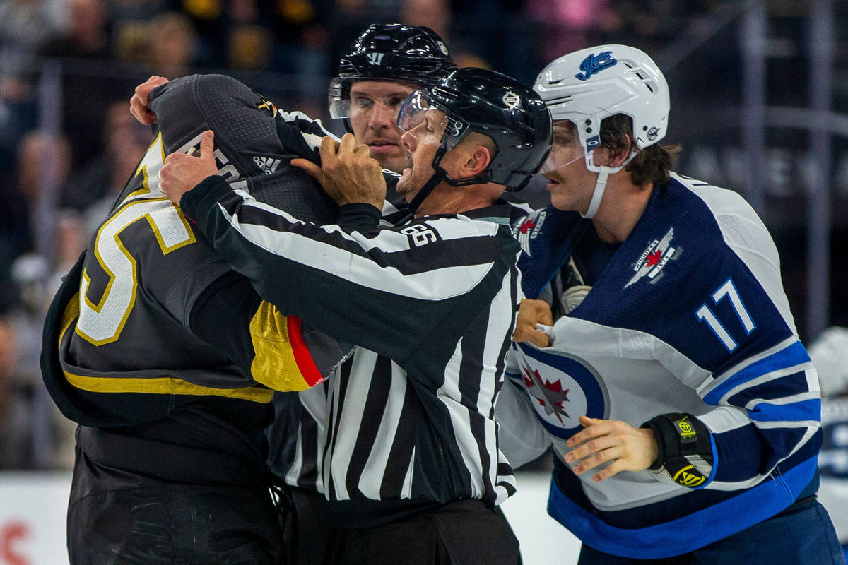 Vegas Golden Knights right wing Ryan Reaves (75) gets help with his jersey from a linesman afte ...