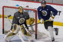 Vegas Golden Knights goaltender Marc-Andre Fleury (29, left) defends the net as right wing Alex ...